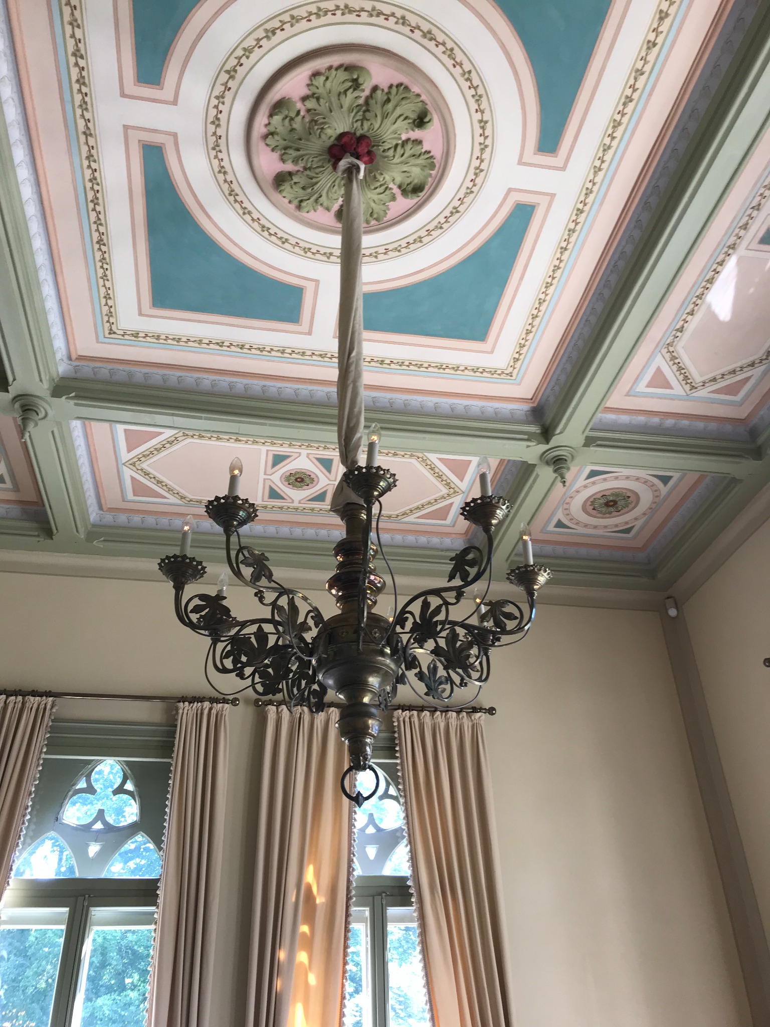 Decorative painted ceiling and chandelier at Evenburg